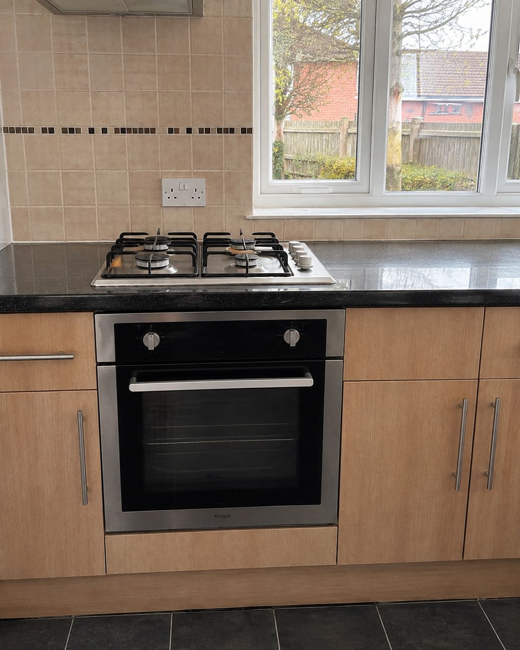 The same kitchen, photographed properly: straightened, shot from the same spot as the before, blinds opened, kit moved out of frame.