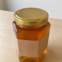 A closer plain photograph of the same jar of honey.
